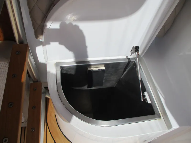 Slide: The Image of Open storage compartment on a 2008 Custom Carolina 53 Sculley boat. - 32