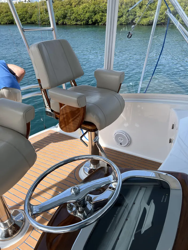 Slide: The Image of Captain's chair and helm of a 2008 Custom Carolina 53 Sculley boat. - 48