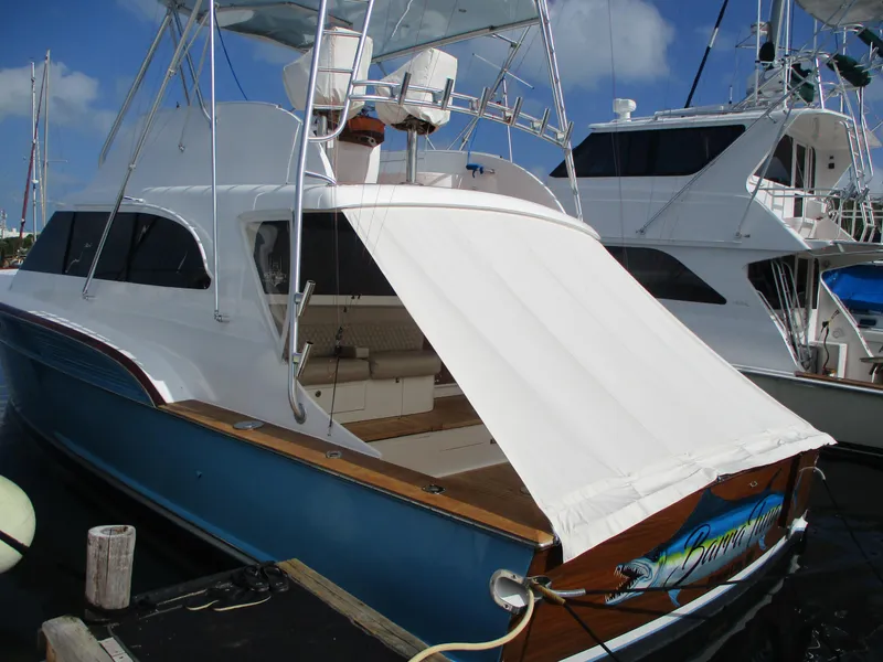 Slide: The Image of 2008 Custom Carolina 53 Sculley yacht docked at marina, featuring blue hull and white canopy. - 6