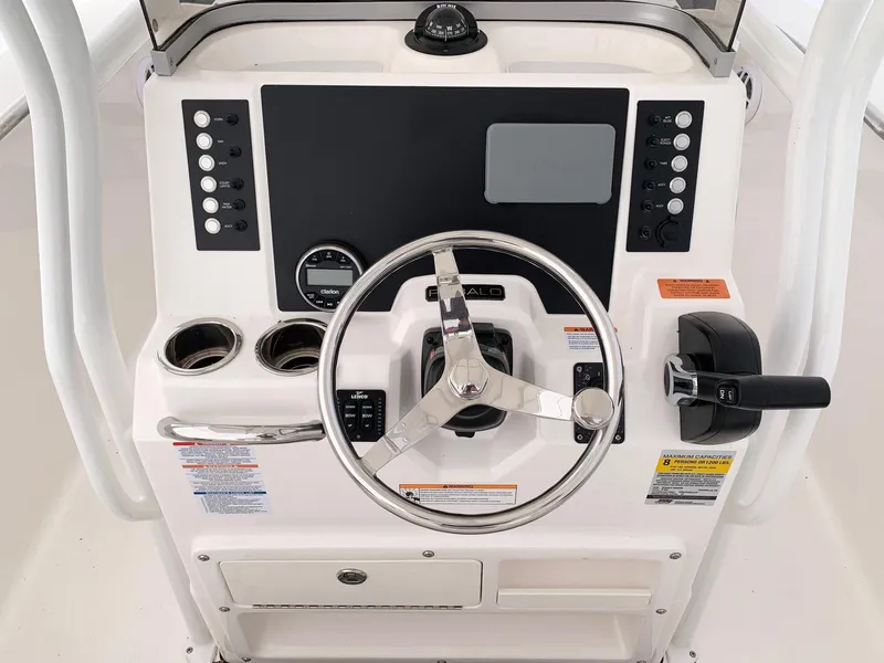 Slide: The Image of 2024 Robalo R200 Center Console boat dashboard with steering wheel and control panel. - 2