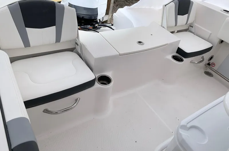 Slide: The Image of 2024 Robalo R200 Center Console boat interior with cushioned seating and cup holders. - 9