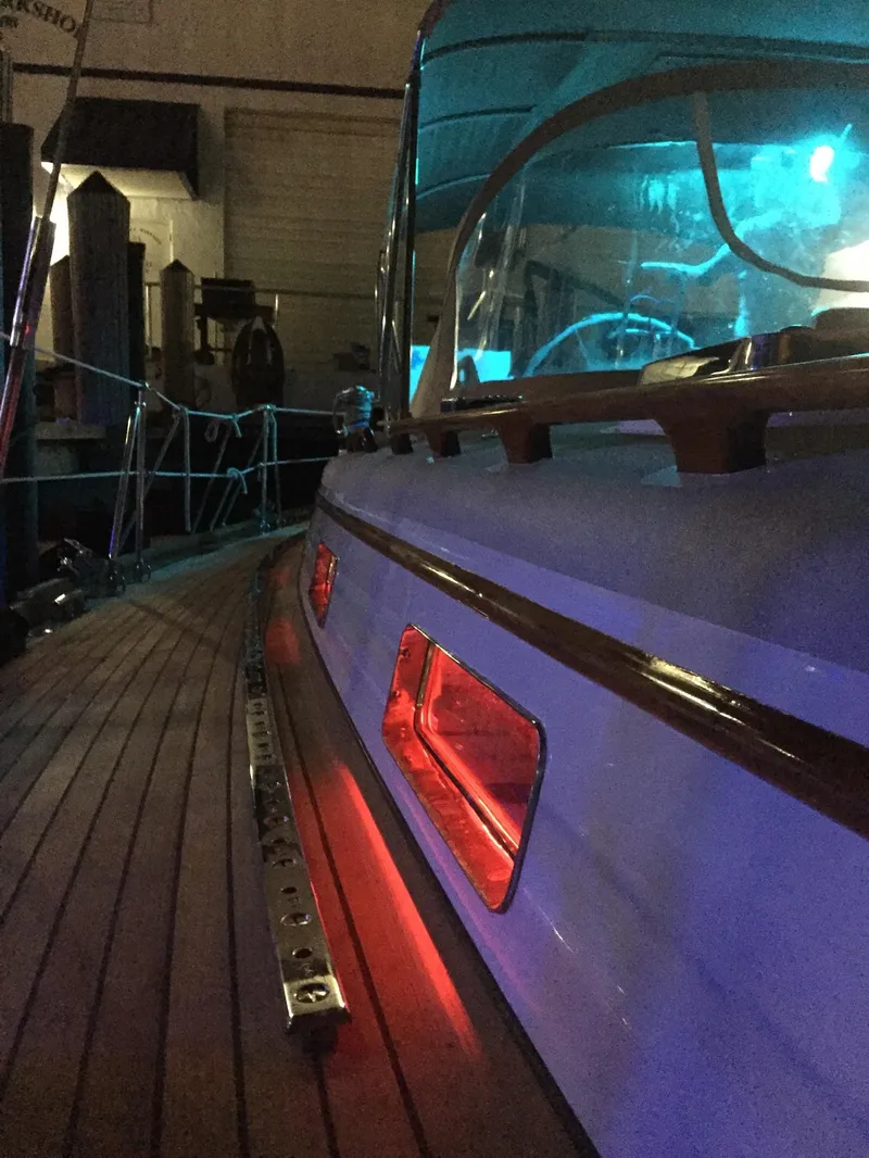 Slide: The Image of 1989 Little Harbor 54 yacht with illuminated deck and vibrant lighting. - 13