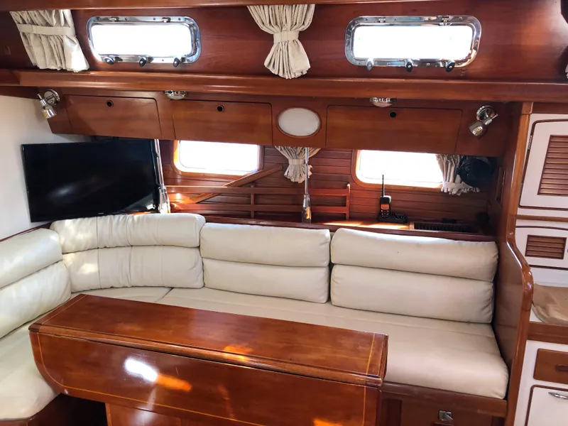 Slide: The Image of Interior of 1989 Little Harbor 54 yacht with wooden finish and cream seating. - 25