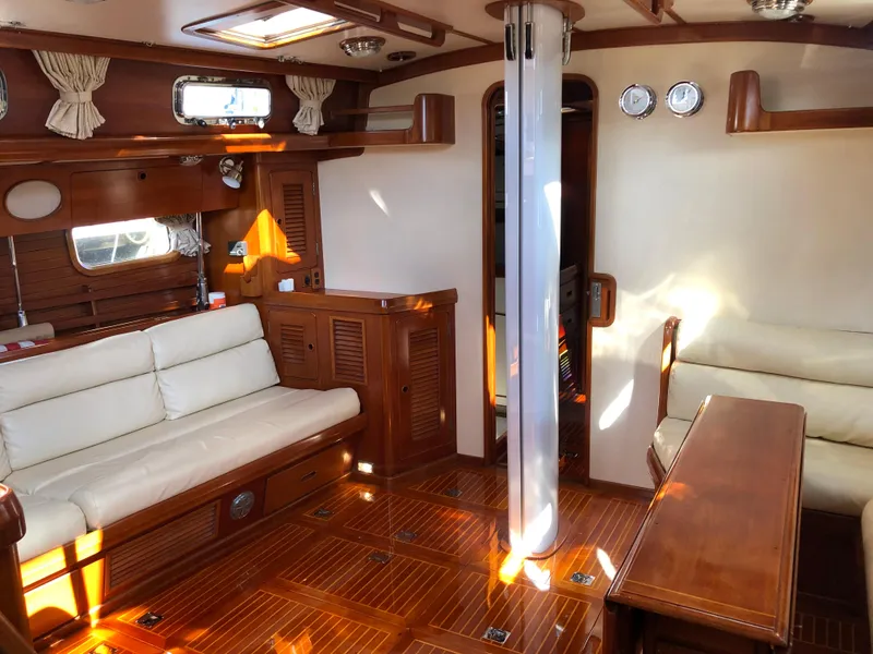 Slide: The Image of Luxurious interior of 1989 Little Harbor 54 yacht with wooden furnishings and white seating. - 26