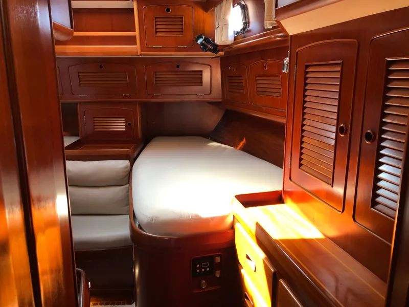 Slide: The Image of Luxurious wooden cabin interior of 1989 Little Harbor 54 yacht with cozy bed and storage. - 38