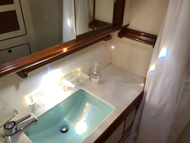 Slide: The Image of Little Harbor 54 yacht bathroom with sink, mirror, and wooden accents, 1989 model. - 40