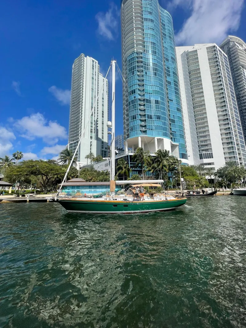 Slide: The Image of Sailboat Little Harbor 54 (1989) docked near modern skyscrapers and waterfront. - 44
