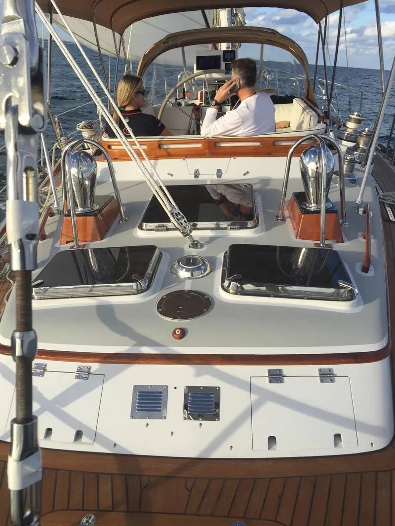 Slide: The Image of 1989 Little Harbor 54 sailboat with people on deck, sailing on open water. - 8