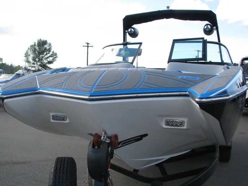 Slide: The Image of 2022 MB F22 Alpha boat on trailer, black and blue design, parked outdoors. - 1