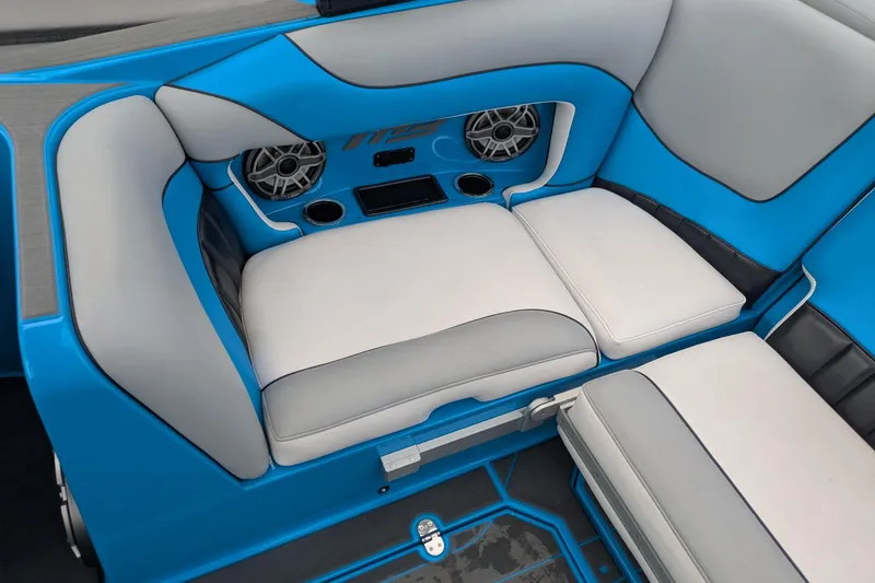 Slide: The Image of 2022 MB F22 Alpha boat interior with blue and gray seating, speakers, and cup holders. - 14