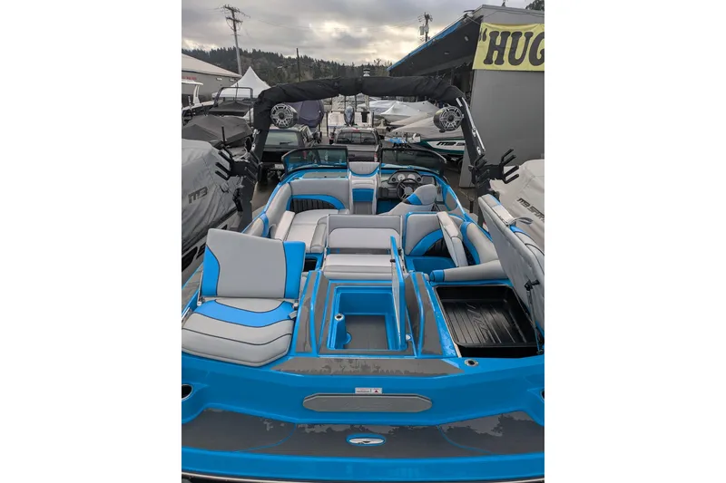 Slide: The Image of 2022 MB F22 Alpha boat with blue and gray interior, docked outdoors. - 18