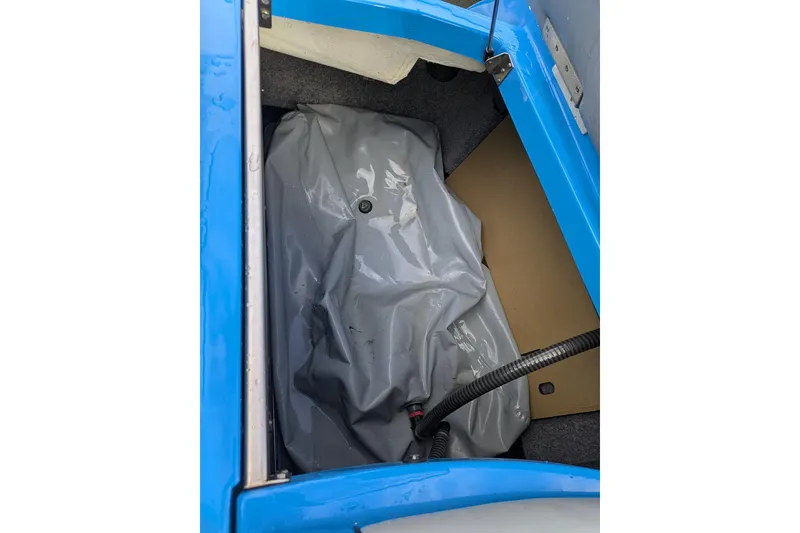Slide: The Image of Blue MB F22 Alpha 2022 boat interior with gray storage compartment. - 20