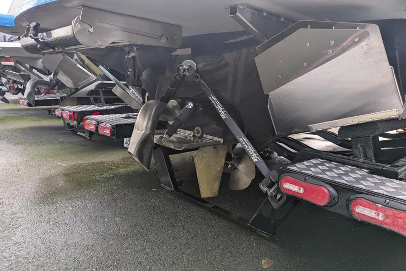 Slide: The Image of Rear view of 2022 MB F22 Alpha boat on trailer, showing propeller and exhaust system. - 22