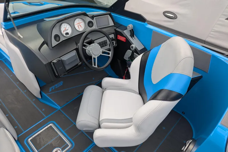 Slide: The Image of 2022 MB F22 Alpha boat interior with modern dashboard and blue-accented captain's seat. - 9
