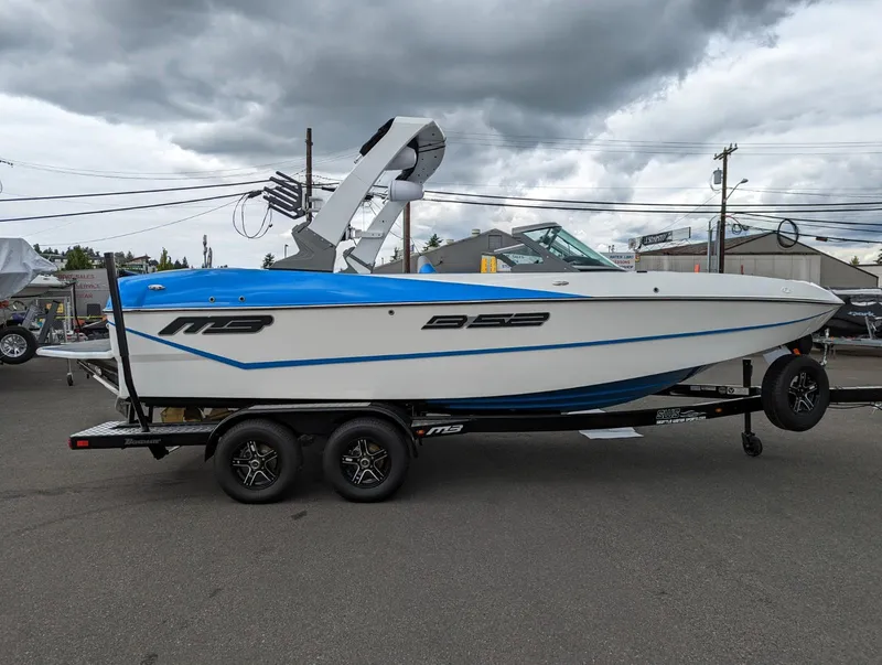 The Image of 2022 MB B52-21 Classic boat on trailer under cloudy sky. - 0