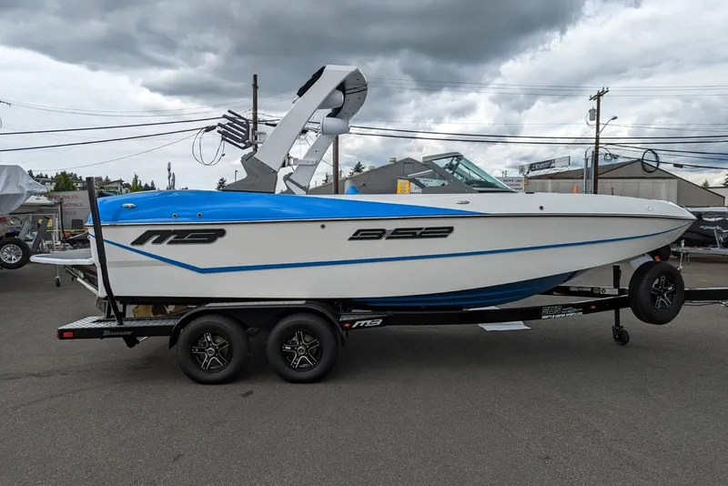 Slide: The Image of 2022 MB B52-21 Classic boat on trailer, white and blue design, parked outdoors. - 15