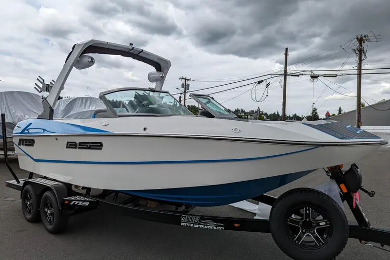 Slide: The Image of 2022 MB B52-21 Classic boat on trailer under cloudy sky. - 16