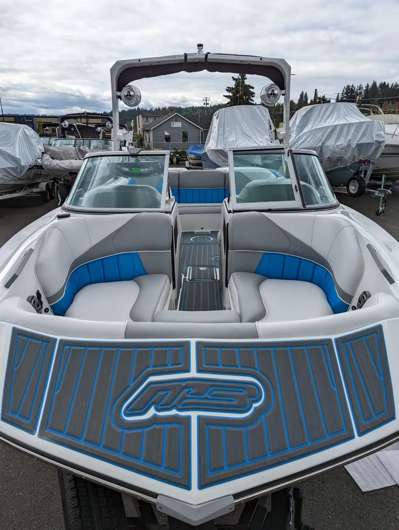 Slide: The Image of 2022 MB B52-21 Classic boat with blue and gray interior, docked. - 3