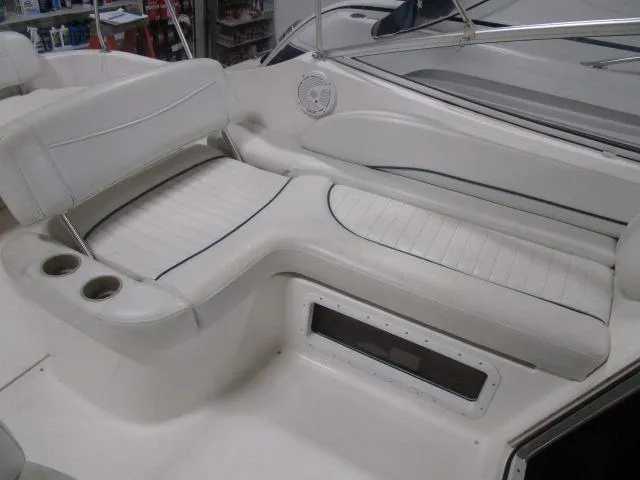 Slide: The Image of 2002 Bayliner 2655 Ciera Sunbridge interior seating with cup holders and speaker. - 10