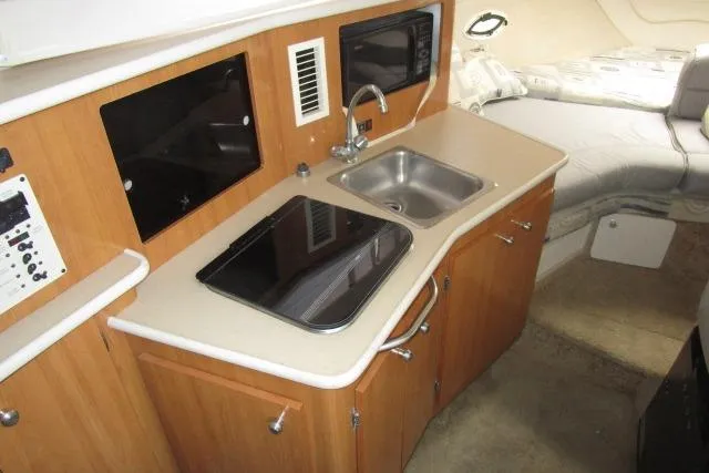 Slide: The Image of 2002 Bayliner 2655 Ciera Sunbridge interior with kitchenette and sleeping area. - 22