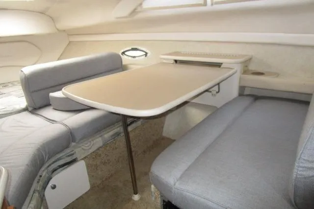 Slide: The Image of Interior of 2002 Bayliner 2655 Ciera Sunbridge with seating and table arrangement. - 24