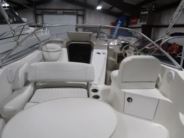 The Image of 2002 Bayliner 2655 Ciera Sunbridge interior with white seating and control panel. - 5