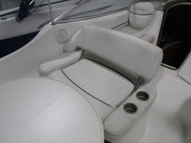 Slide: The Image of 2002 Bayliner 2655 Ciera Sunbridge interior with white seating and table. - 6