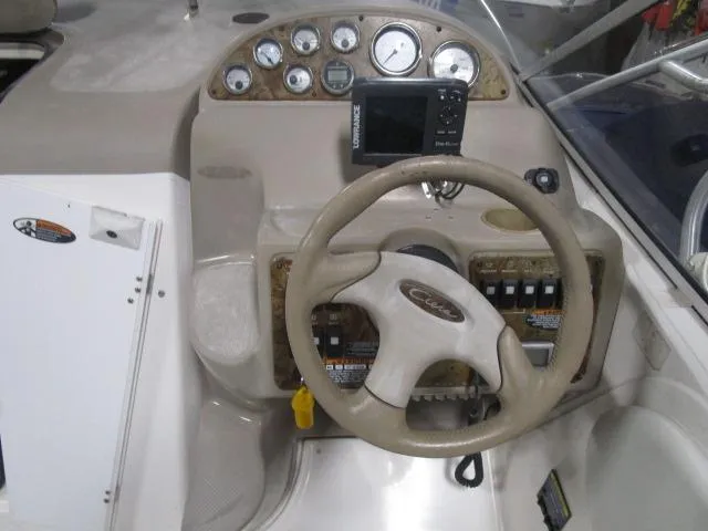 Slide: The Image of 2002 Bayliner 2655 Ciera Sunbridge dashboard with steering wheel and gauges. - 7