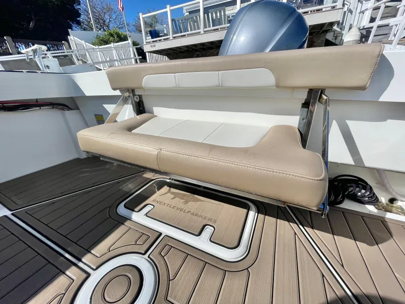 Slide: The Image of 2017 Parker 2320 Sport Cabin boat with foldable bench seat. - 11