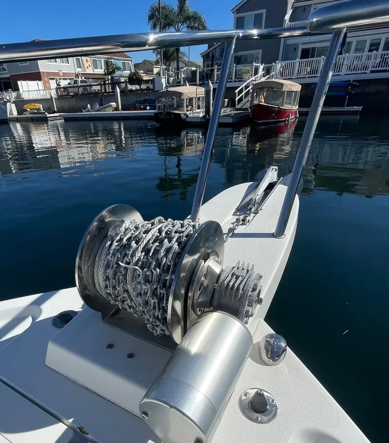 Slide: The Image of 2017 Parker 2320 Sport Cabin boat with anchor winch in a marina. - 15