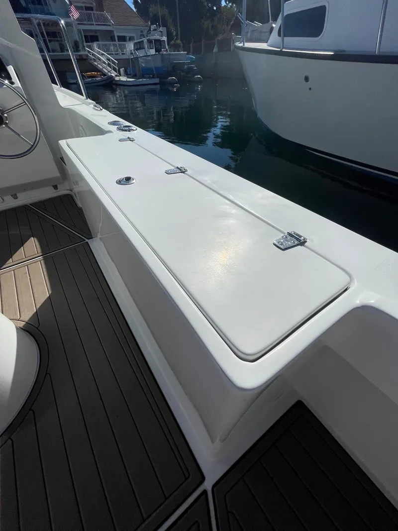 Slide: The Image of 2017 Parker 2320 Sport Cabin boat deck with storage compartment. - 16