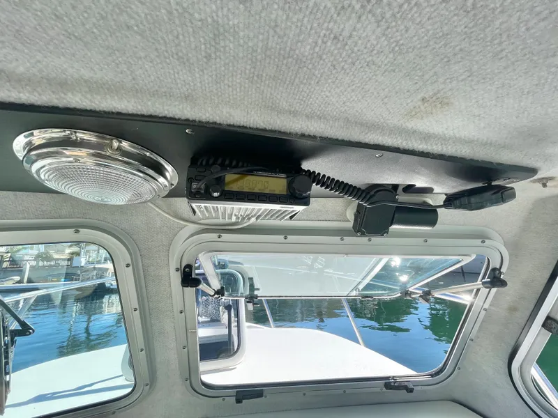 Slide: The Image of Interior view of 2017 Parker 2320 Sport Cabin boat with radio equipment. - 4