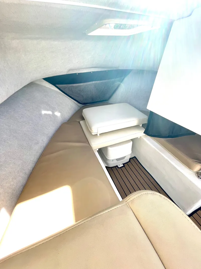 Slide: The Image of Interior cabin of a 2017 Parker 2320 Sport Cabin boat with beige seating. - 5