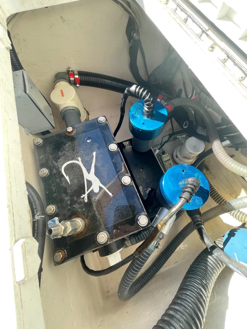 Slide: The Image of Engine compartment of a 2017 Parker 2320 Sport Cabin boat with various components. - 9