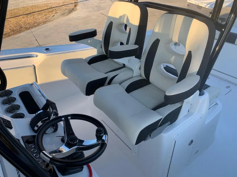 Slide: The Image of 2024 Cape Horn 32T boat cockpit with dual captain's chairs and steering wheel. - 10
