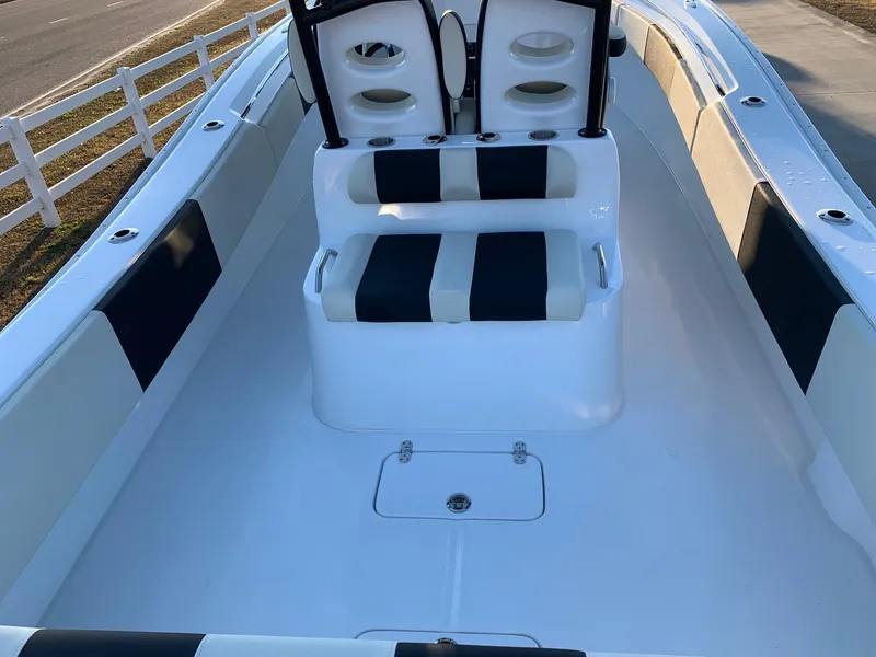 Slide: The Image of 2024 Cape Horn 32T boat interior with dual seats and white-black upholstery. - 19