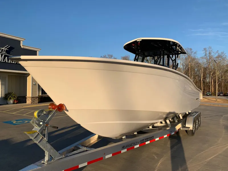 Slide: The Image of 2024 Cape Horn 32T boat on a trailer in a parking lot. - 21