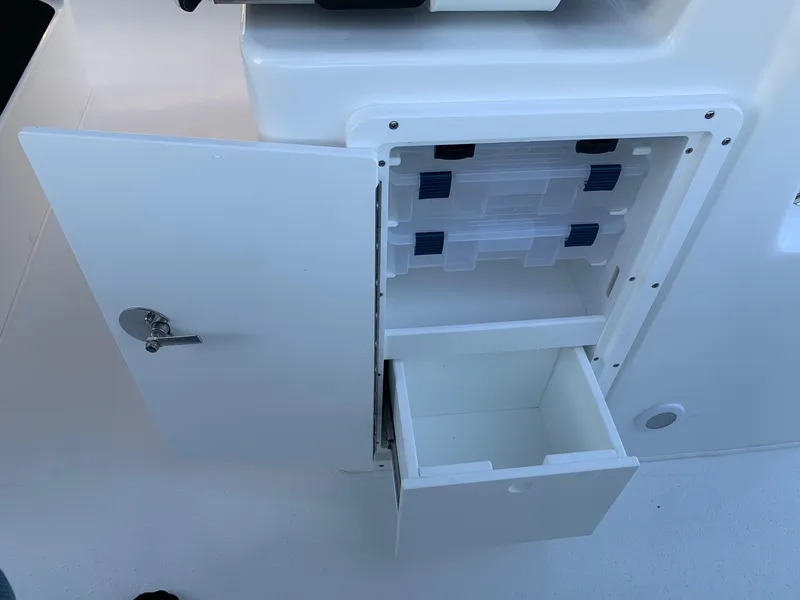 Slide: The Image of Cape Horn 32T 2024 boat storage compartment with open door and drawers. - 11
