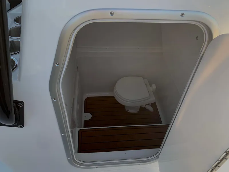 Slide: The Image of 2024 Cape Horn 32T boat interior with compact marine toilet and wooden flooring. - 9