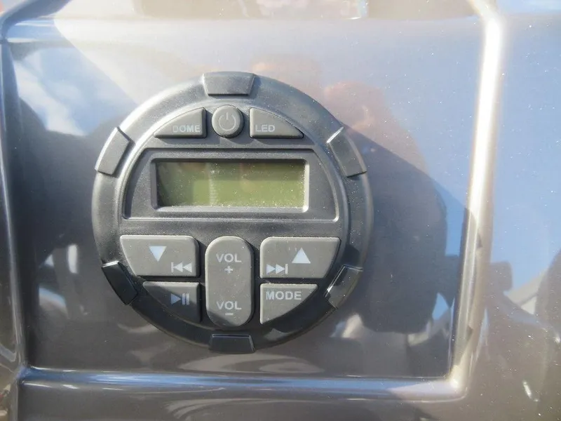 Slide: The Image of 2022 Coach Pontoons 241 RFC control panel with volume and mode buttons. - 13