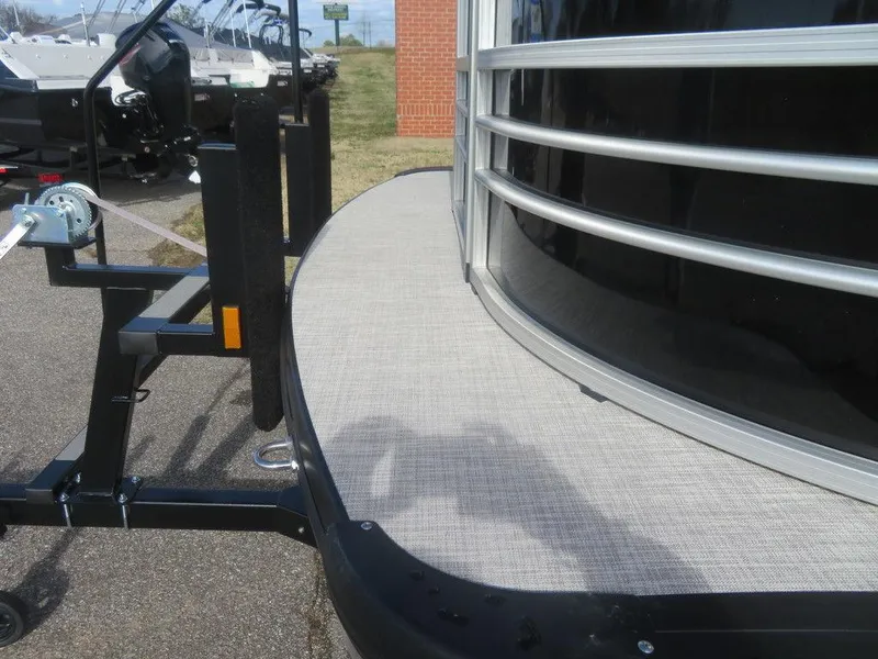 Slide: The Image of 2022 Coach Pontoons 241 RFC on trailer, close-up of deck and railing. - 18