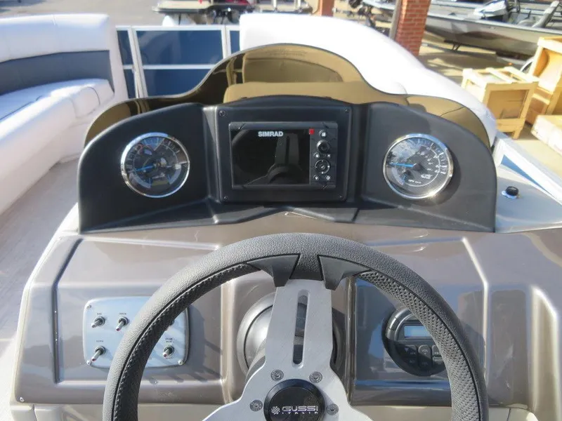 Slide: The Image of 2022 Coach Pontoons 241 RFC dashboard with steering wheel and navigation system. - 24