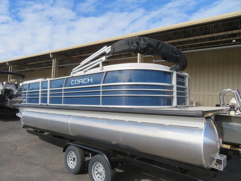 Slide: The Image of 2022 Coach Pontoons 241 RFC on trailer, blue and silver, docked outdoors. - 3