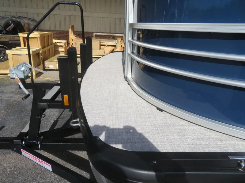 Slide: The Image of 2022 Coach Pontoons 241 RFC boat trailer close-up with winch and deck. - 7