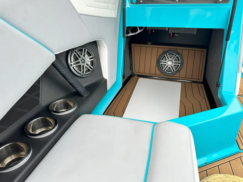 Slide: The Image of 2022 Nautique S23 boat interior with speakers and cup holders. - 10