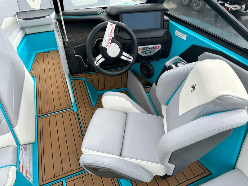 Slide: The Image of 2022 Nautique S23 boat interior with captain's chair, steering wheel, and touchscreen display. - 8