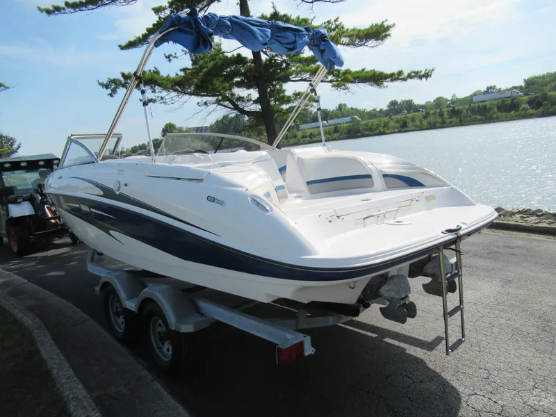 Slide: The Image of 2004 Yamaha Boats SX230 on trailer by a lake. - 1