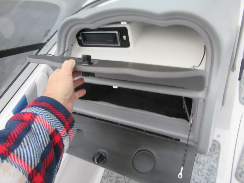Slide: The Image of Hand opening glove compartment in 2004 Yamaha Boats SX230. - 14