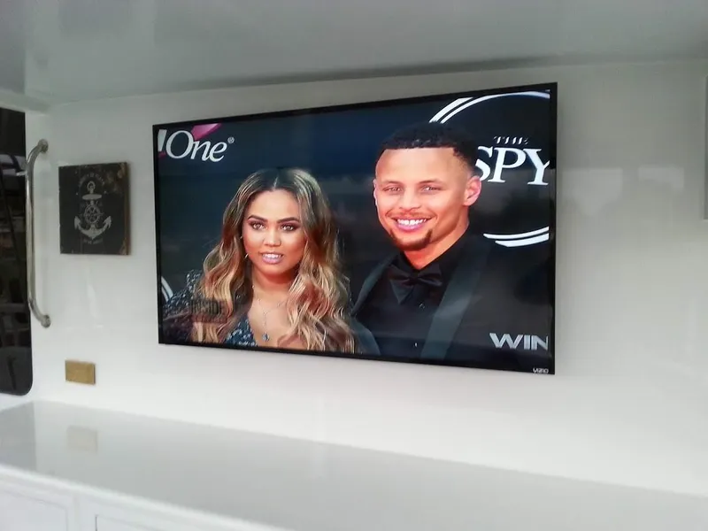 Slide: The Image of TV on Jutson 46 LRC yacht displaying a couple at an event. - 16