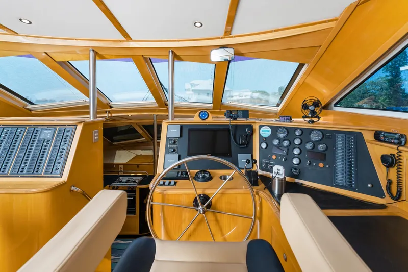 Slide: The Image of Interior helm of 2000 Jutson 46 LRC yacht with modern navigation equipment and wooden finish. - 33